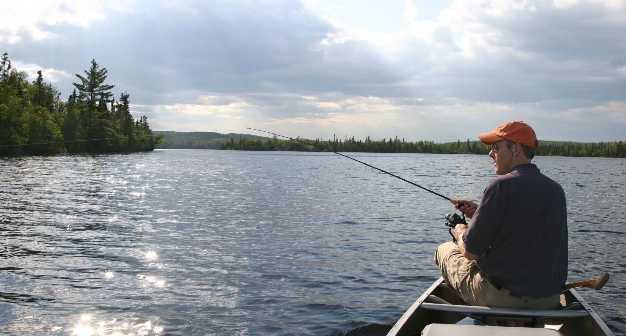 Man fishing from a canoe in northern Minnesota's Arrowhead regionPLEASE CLICK ON THE IMAGE BELOW TO VIEW MY FISHING LIGHTBOX: