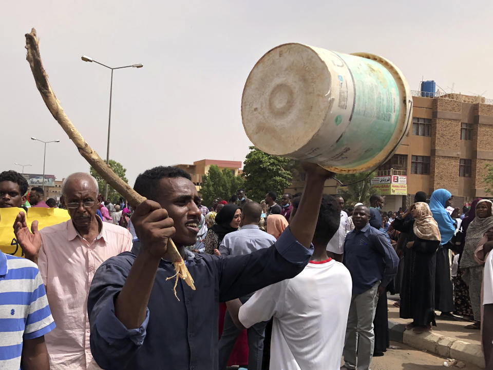 A Sudanese protester bangs on a bucket during a demonstration against the military council, in Khartoum, Sudan, Sunday, June 30, 2019. Tens of thousands of protesters have taken to the streets in Sudan's capital and elsewhere in the country calling for civilian rule nearly three months after the army forced out long-ruling autocrat Omar al-Bashir. The demonstrations came amid a weekslong standoff between the ruling military council and protest leaders. (AP Photo/Hussein Malla)