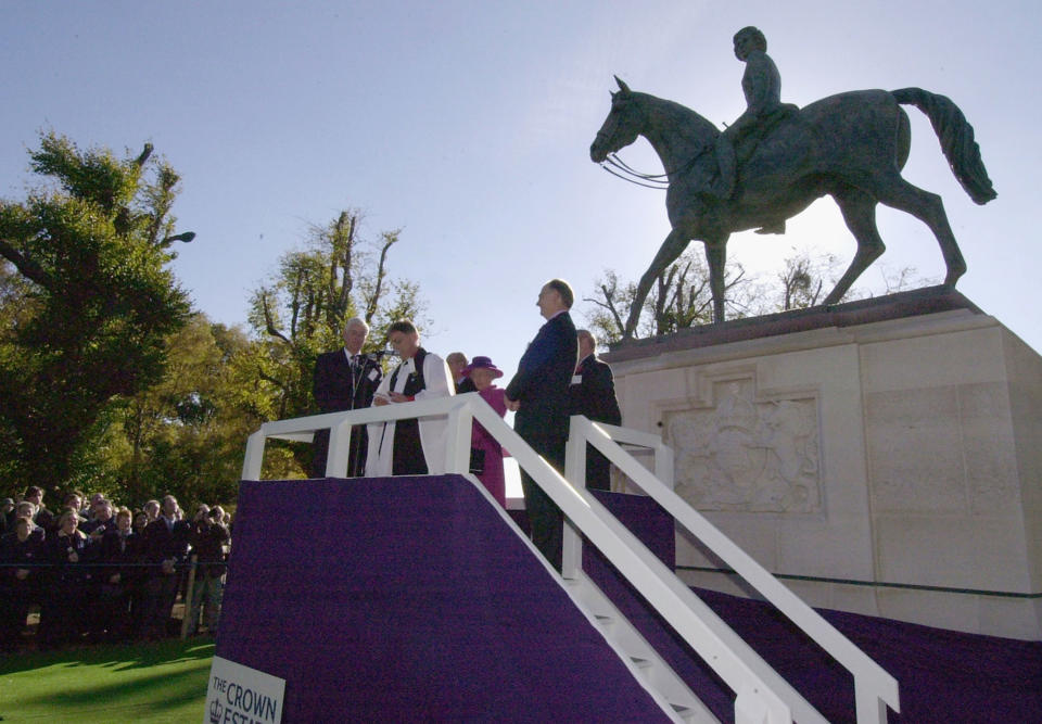 <p>The Queen unveils a statue of herself on horseback in Great Windsor Park on 27 October, 2003. The statue, by Philip Jackson, is the first that the Queen has unveiled of herself and looks towards Windsor Castle. (Getty Images)</p> 