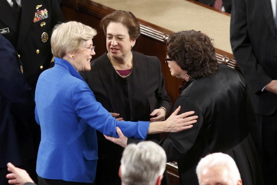 U.S. Senator Warren talks with U.S. Supreme Court Associate Justices Kagan and Sotomayor before President Obama delivers his State of the Union address to a joint session of Congress in the U.S. Capitol in Washington