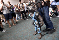 <p>Mike Asanuma, from Los Angeles, controls a puppet of Rocket from <em>Guardians of the Galaxy</em> at Comic-Con International on July 20 in San Diego. (Photo: Chris Pizzello/Invision/AP) </p>