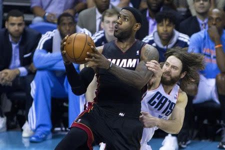 Miami Heat forward LeBron James (6) drives to the basket while being defended by Charlotte Bobcats forward Josh McRoberts (11) during the fourth quarter in game four of the first round of the 2014 NBA Playoffs at Time Warner Cable Arena. Apr 28, 2014; Charlotte, NC, USA;USA TODAY Sports