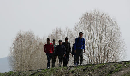 A group of Afghan migrants walk along a main road after crossing the Turkey-Iran border near Erzurum, eastern Turkey, April 12, 2018. Picture taken April 12, 2018. REUTERS/Umit Bektas