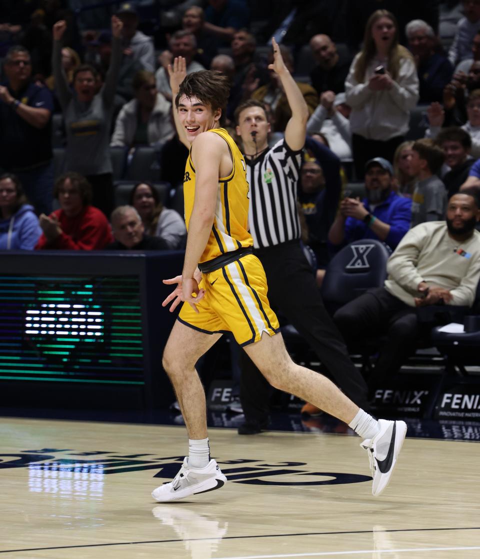 Zach Green of Moeller celebrates making a 3-point shot, giving the Crusaders a 67-65 lead with 1:27 left in the second OT. Moeller played Centerville in a Division I regional final. Centerville ultimately won in double overtime 70-69.