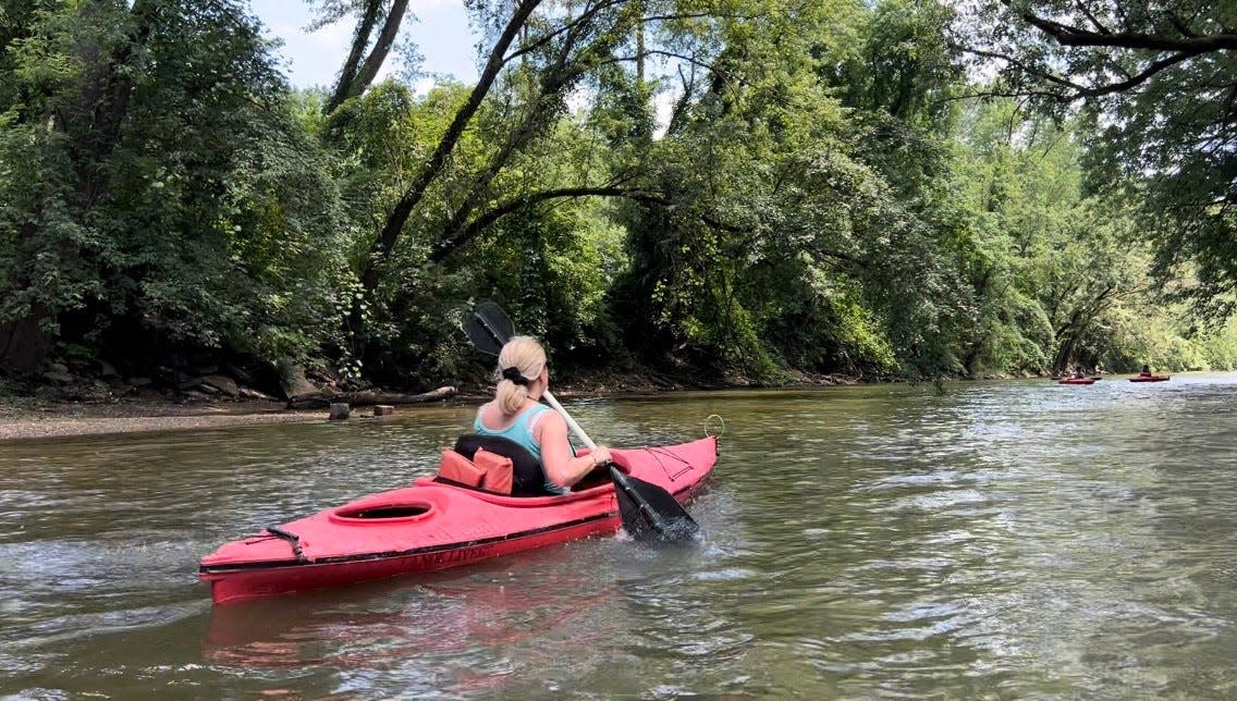 A kayaker floats down the Tuscarawas River in the Massillon area earlier this month. Kayaking trips are a fun activity before summer ends.