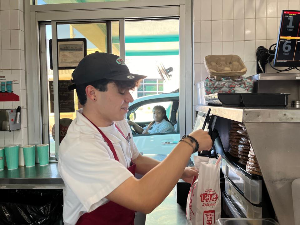 Antonio Barron gets an order ready at the drive-thru window on P. Terry's Giving Back Day, which benefits Season for Caring.