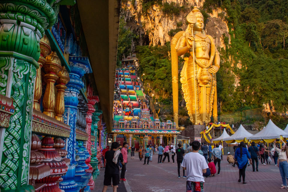Side view of Batu Caves temple main entrance with Murugan Statue in the front in Kuala Lumpur, Malaysia, Asia