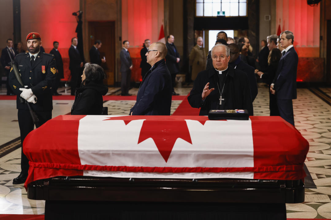 A priest pays his respects as former prime minister Brian Mulroney lies in state in the Sir John A. Macdonald building opposite Parliament Hill in Ottawa, on Tuesday, March 19, 2024. THE CANADIAN PRESS/Blair Gable-Pool