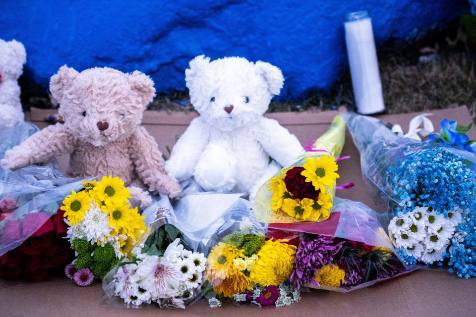 Bears and flowers sit in front of a rock painted to memorialize Perry High School shooting victim Ahmir Jolliff at Perry High School on Saturday, Jan. 6, 2024, in Perry.