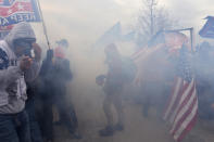 Trump supporters clash with police and security forces as they try to storm the US Capitol surrounded by tear gas in Washington, DC on January 6, 2021. (Photo by JOSEPH PREZIOSO/AFP via Getty Images)