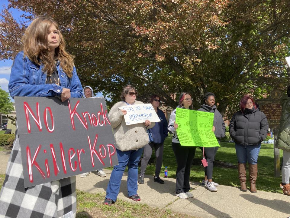 Protesters stand on a street corner in Carrollton, Ky. on Monday, April 24, 2023, to protest the hiring of a former Louisville police officer who shot Breonna Taylor. Myles Cosgrove was recently hired by the Carroll County sheriffs department. (AP Photo/Dylan Lovan)