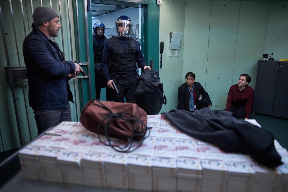 Sunetra Sarker as Varisha (on floor) getting caught up in the bank heist with Rowan and Patrick.