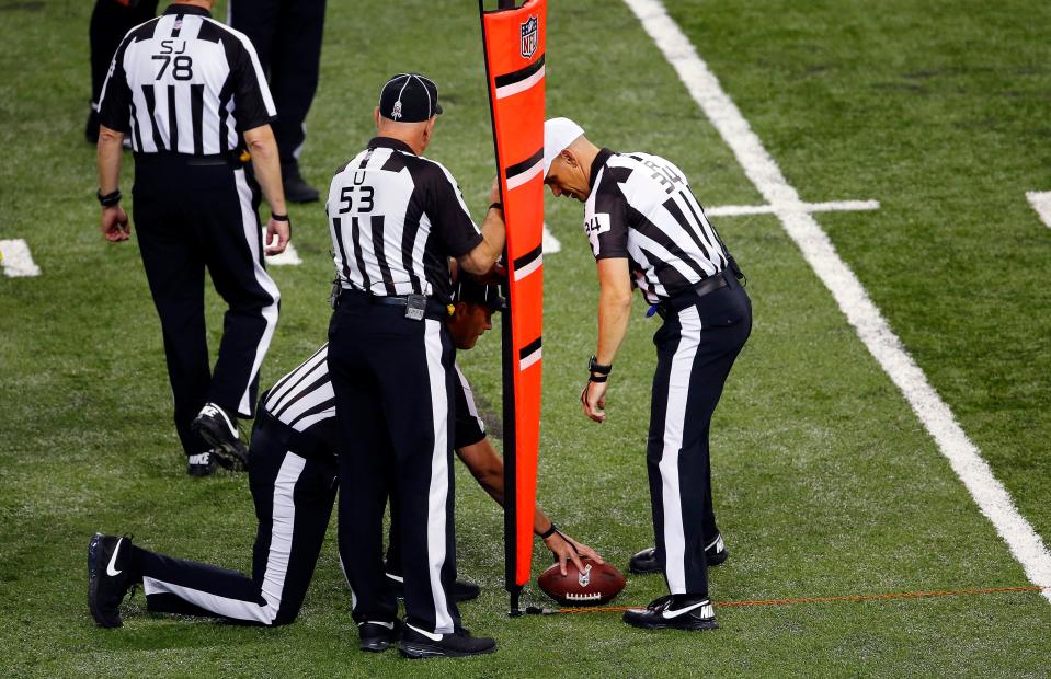 Referee Clete Blakeman (34) measures for a first down during the second quarter of an NFL football game between the Detroit Lions and Tampa Bay Buccaneers at Ford Field in Detroit, Sunday, Nov. 24, 2013.