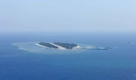 An aerial photo taken though a glass window of a Taiwanese military plane shows the view of Itu Aba, which the Taiwanese call Taiping, at the South China Sea, March 23, 2016. REUTERS/Ministry of Foreign Affairs/Handout via Reuters