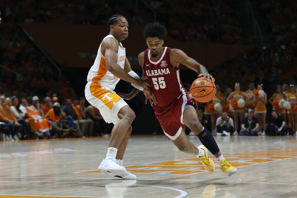 Alabama guard Aaron Estrada (55) moves the ball against Tennessee guard Jordan Gainey (2) during their game in January at Thompson-Boling Arena at Food City Center.