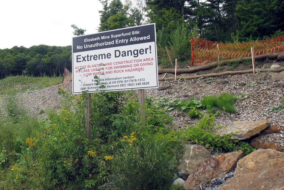 A warning sign stands outside the Elizabeth Mine in Strafford, Vt. The U.S. Environmental Protection Agency says its 20-year cleanup of the former copper mine cost $103 million.