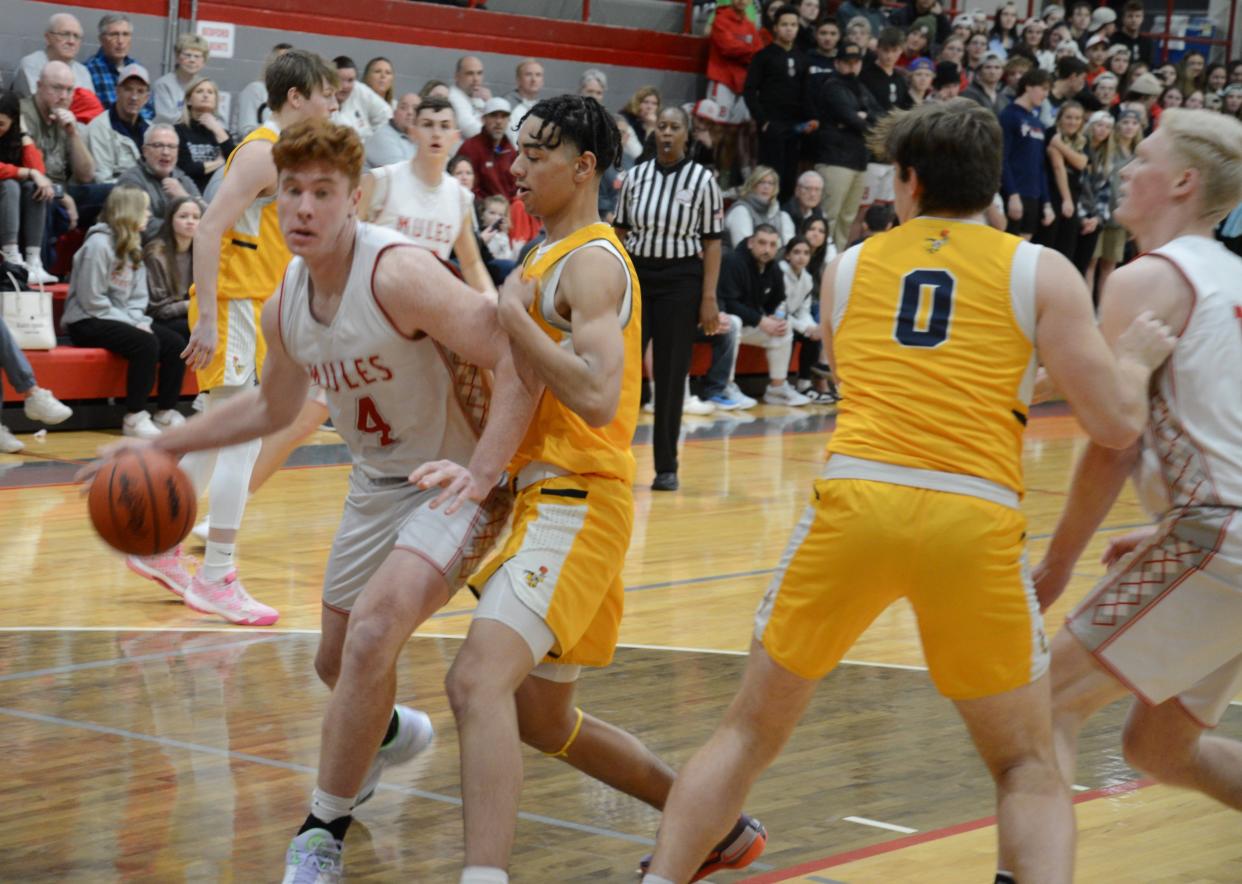 Simon Eighmey of Bedford drives the baseline against Harrison Rogers of Saline Friday night.