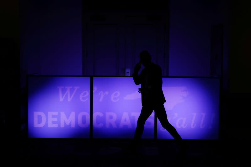 An attendee walks past a sign outside of a North Carolina Democratic Party event in Charlotte, North Carolina