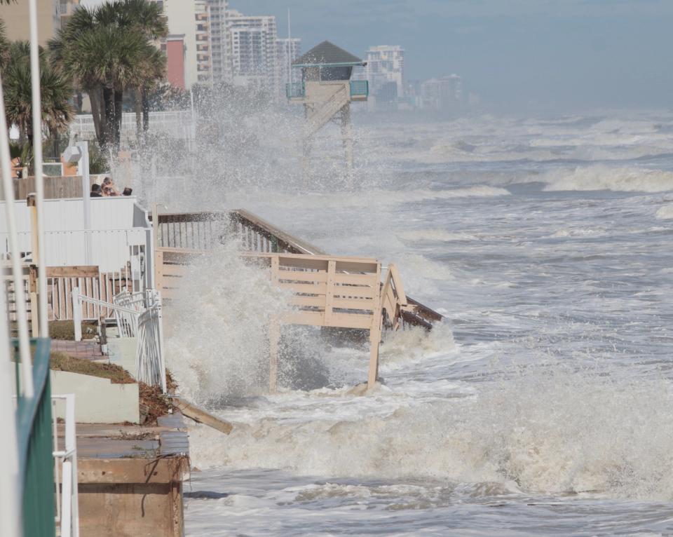 Strong surf batters the seawall in Daytona Beach Shores as residents and business owners start to survey damage from the storm.