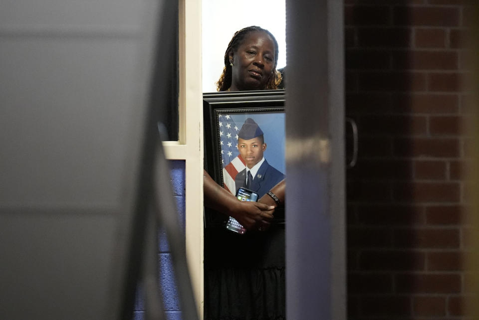 Chantemekki Fortson, mother of slain Roger Fortson, a U.S. Air Force senior airman, holds a photo of her son before a news conference with attorney Ben Crump on Monday, June 3, 2024, in Atlanta. (AP Photo/Brynn Anderson)