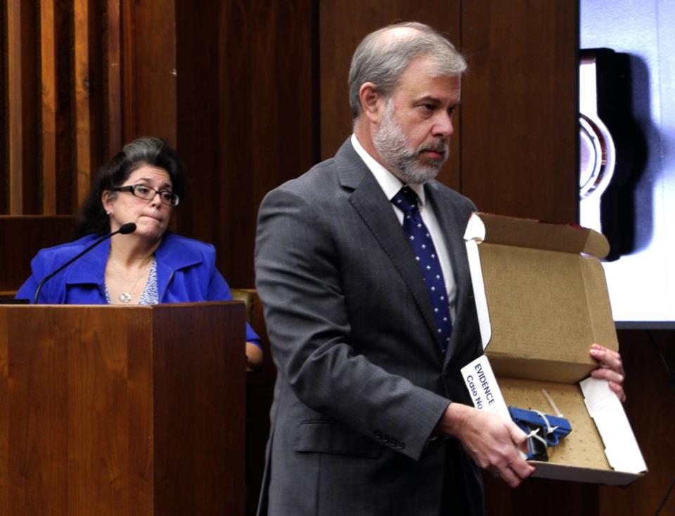 Chief Assistant District Attorney Don Kelly, right, shows a firearm to the jury Monday morning during the testimony of Sgt. Dawn Tuning of the Columbus Police Department. 09/26/2022