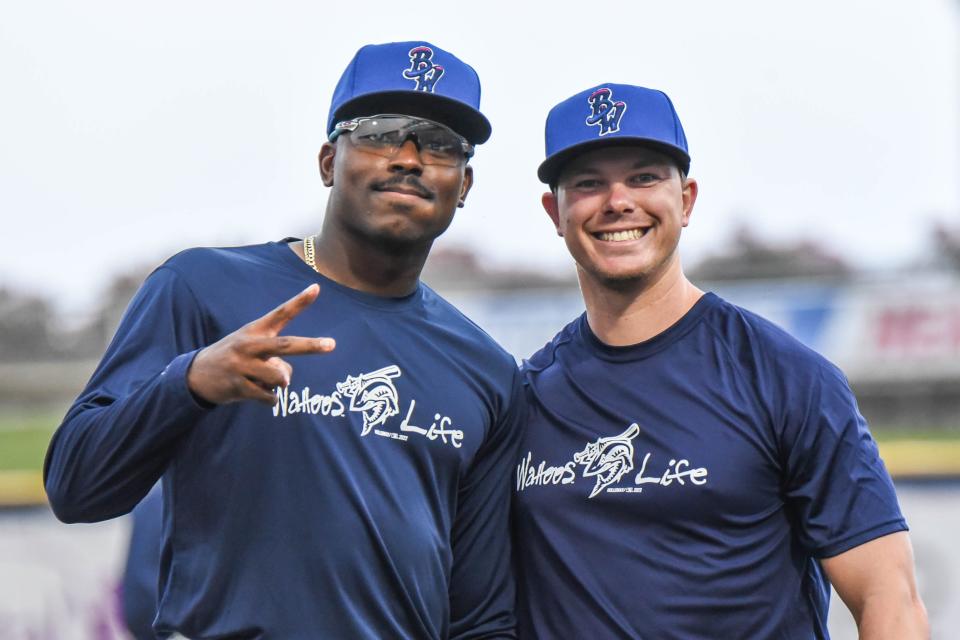 Demetrius Sims, left, shown with Troy Johnston, returned to the Blue Wahoos last week and produced a team-best 5 RBI night in loss to Biscuits.