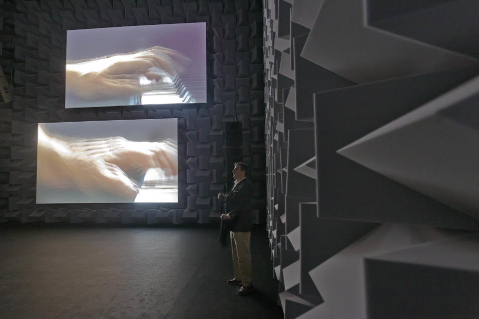 In this photo taken Wednesday, May 29, 2013, a man visits a video installation part of artist Anri Sala's exhibition in the French Pavilion during a preview of the 55th edition of the Venice Biennale of Arts in Venice, northern Italy, Wednesday, May 29, 2013. (AP Photo/Domenico Stinellis)