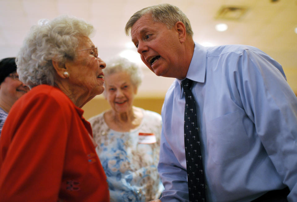 Sen. Lindsey Graham, right, speaks with Erminie Nave, left, after speaking at a campaign stop at American Legion Post 20 on Wednesday, April 23, 2014, in Greenwood, S.C. (AP Photo/Rainier Ehrhardt)