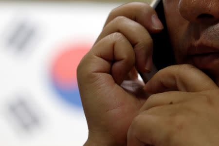 A North Korean defector, who declined to be named and requested his face not to be photographed due to his safety, talks on his phone during an interview with Reuters in Seoul, South Korea, September 26, 2016. REUTERS/Kim Hong-Ji