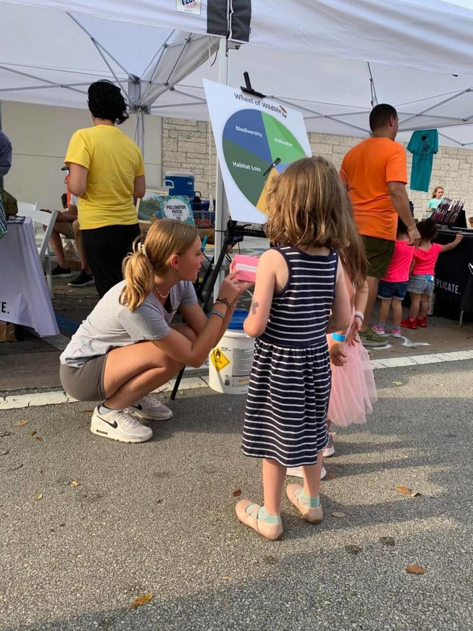  Gold Award Girl Scout Ceci Ise teaches children about native plants at Bound by Beauty’s booth at Green Day in Miami Shores. 