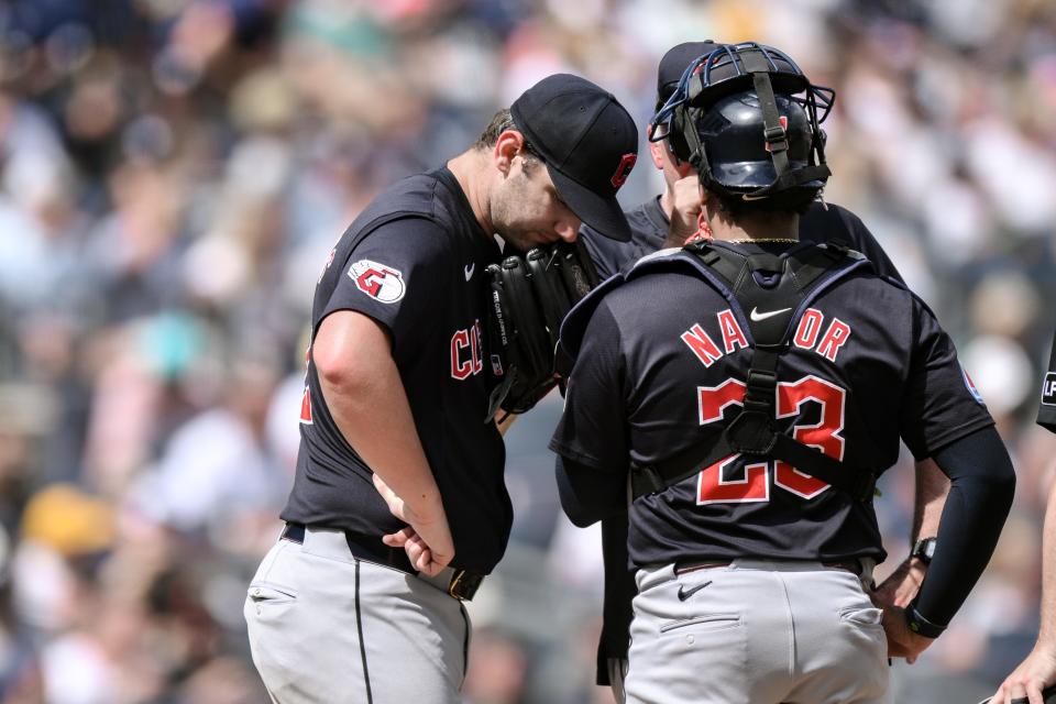 Aug 22, 2024; Bronx, New York, USA; Cleveland Guardians pitcher Gavin Williams (32) has a conference at the mound with Cleveland Guardians catcher Bo Naylor (23) and Cleveland Guardians pitching coach Carl Willis (51) during the fifth inning against the New York Yankees at Yankee Stadium. Mandatory Credit: John Jones-USA TODAY Sports