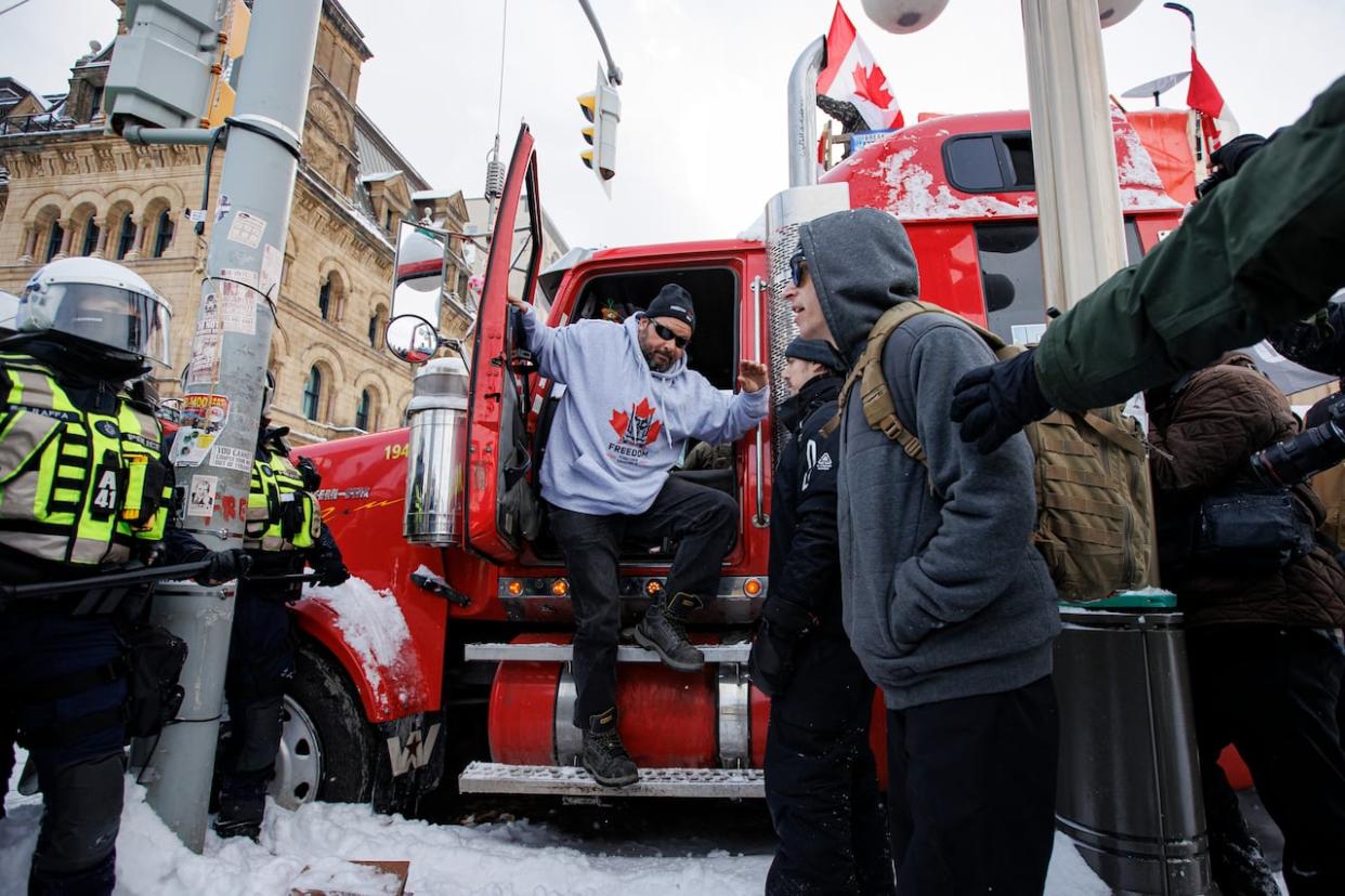 A trucker is seen surrendering his vehicle on Feb. 19, 2022 as police enforce an injunction against protesters, some who had been camped in their rigs near Parliament Hill for weeks. A lawyer representing some of the protest organizers in a civil challenge argued Thursday for the case to be thrown out.  (Evan Mitsui/CBC - image credit)