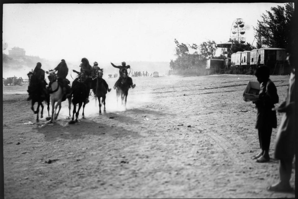 Men ride horses next to Qargha Lake on the outskirts of Kabul, Afghanistan, Friday, June 9, 2023. (AP Photo/Rodrigo Abd)