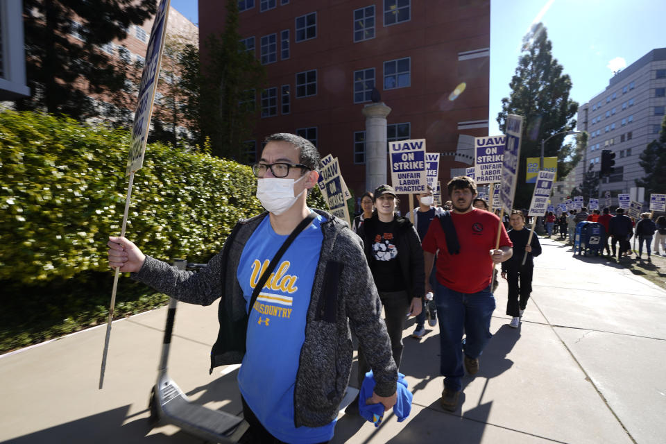 People participate in a protest outside the University of California Los Angeles campus in Los Angeles, Monday, Nov. 14, 2022. Nearly 48,000 unionized academic workers at all 10 University of California campuses have walked off the job Monday. (AP Photo/Damian Dovarganes)