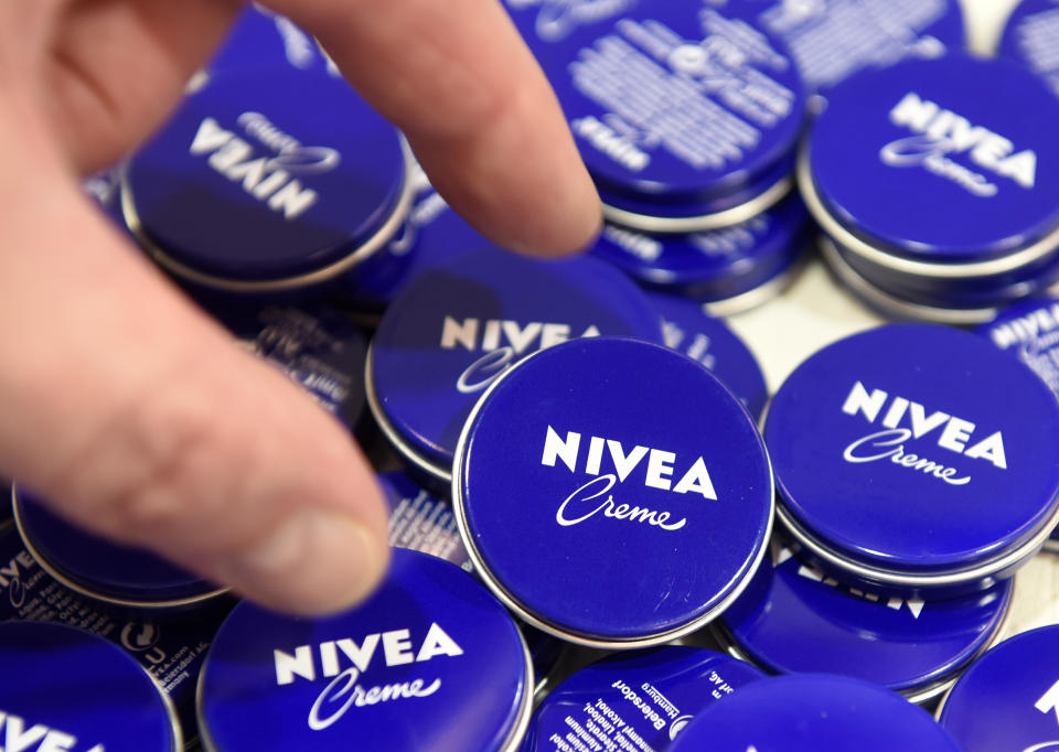 A shareholder of German care cosmetic company Beiersdorf, picks up a Nivea tin before the start of the shareholder meeting in Hamburg, March 31, 2016. REUTERS/Fabian Bimmer