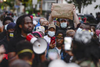 FILE - In this Sept. 2, 2020, file photo, a crowd of protesters gather in Rochester, N.Y., near the site where Daniel Prude was restrained by police officers. In a decision announced Tuesday, Feb. 23, 2021, a grand jury voted not to charge officers shown on body camera video holding Daniel Prude down naked and handcuffed on a city street last winter until he stopped breathing. His brother Joe Prude said Wednesday, Feb. 24 he had viewed police body camera footage showing what happened after officers caught up with Daniel Prude, naked on a frigid March night, as irrefutable proof of a crime. (AP Photo/Adrian Kraus, File)