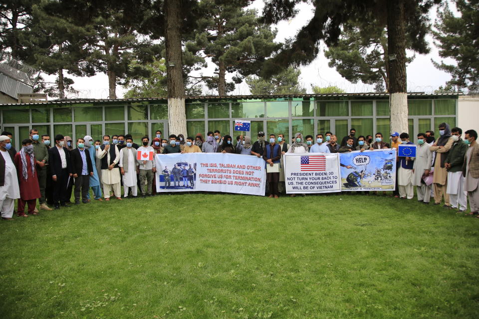 In this Friday, April 30, 2021, photo former Afghan interpreters hold placards during a protest against the U.S. government and NATO in Kabul, Afghanistan. (AP Photo/Mariam Zuhaib)