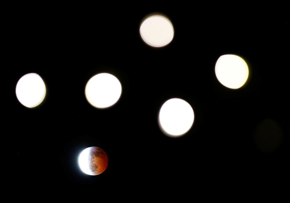 Lights strung up on trees mimic the moon's shape during a lunar eclipse at Seattle Center in Seattle, Washington, U.S. January 20, 2019. REUTERS/Lindsey Wasson