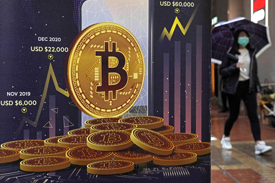 FILE - An advertisement for Bitcoin cryptocurrency is displayed on a street in Hong Kong, on Feb. 17, 2022. California on Wednesday, May 4, 2022, became the first state to formally begin examining how to adapt to cryptocurrency and related technologies, following in the path laid out by President Joe Biden in March. (AP Photo/Kin Cheung, File)