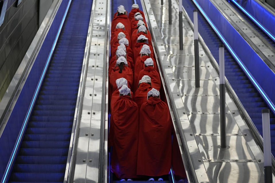 File - Protesters supporting women's rights dressed as characters from The Handmaid's Tale TV series traveling to a protest against plans by Prime Minister Benjamin Netanyahu's new government to overhaul the judicial system, at a railway station in Jerusalem, Wednesday, March 1, 2023. (AP Photo/Ohad Zwigenberg, File)