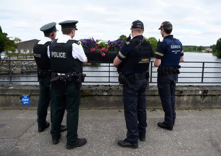 Officers of the Northern Ireland Police Service chat with colleagues from Ireland's Garda at the borderline between Northern Ireland and Ireland in St Belleek, in Fermanagh, Northern Ireland, July 19, 2018. REUTERS/Clodagh Kilcoyne