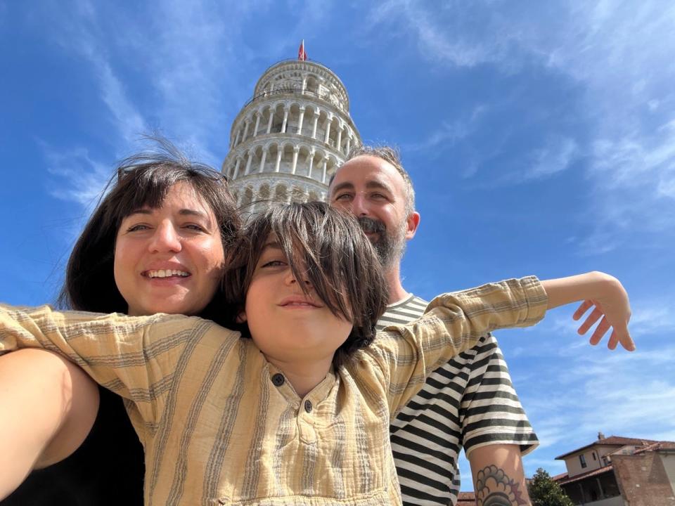 Author Lana Katsaros, her husband, and her son posing in front of a monument