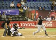 Tigres of Aragua player Yadir Drake, from Cuba, hits an single during the opening winter season game against Leones de Caracas in Caracas, Venezuela, Tuesday, Nov. 5, 2019. Drake said that when he and the other players step onto the diamond, politics is the last thing on their minds, especially when fans start shouting. (AP Photo/Ariana Cubillos)