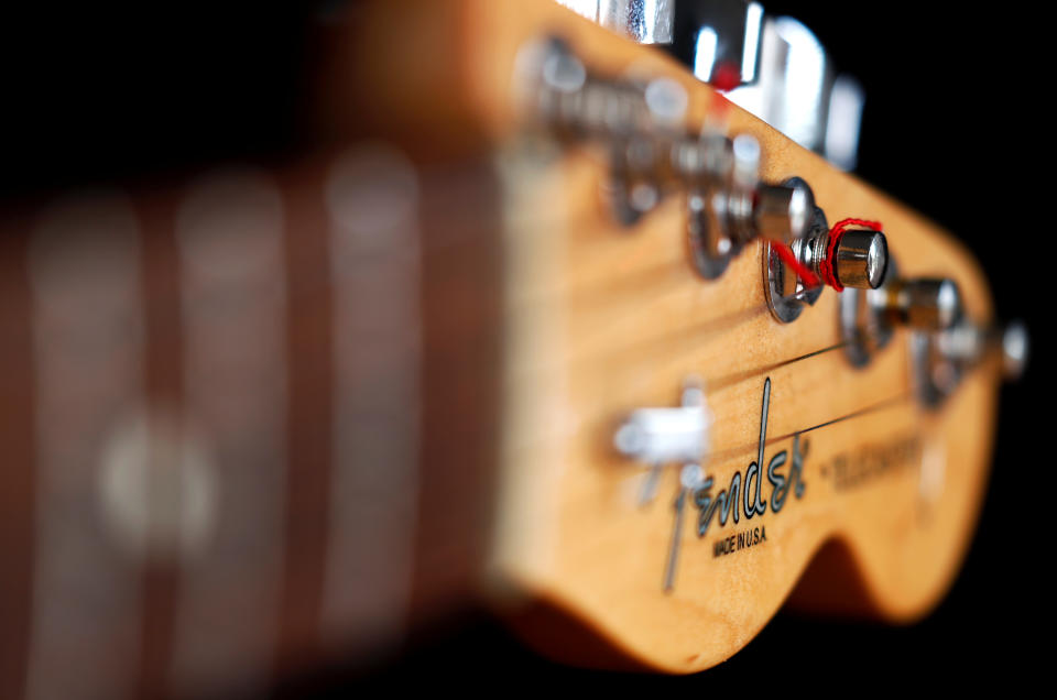 A close up of a Fender guitar.