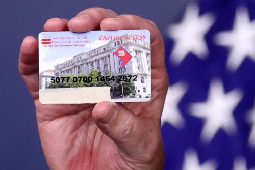 Tom Vilsack, US agriculture secretary holds a food assistance card on 5 May 2021.