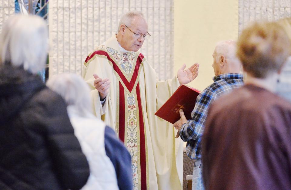 The Rev. Thomas Tyler begins a weekday morning Mass at Holy Cross Catholic Church in Fairview on April 19.