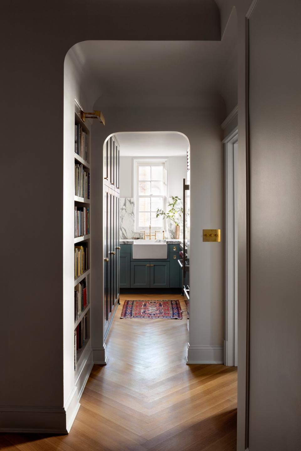 AFTER: Custom rift-sawed white oak flooring was installed throughout the apartment in an oversized herringbone pattern. “The millwork in the apartment was done by the exact same company that did them in 1925,” Nicholas says. Forbes & Lomax switches were also used throughout the apartment for a throwback feel.