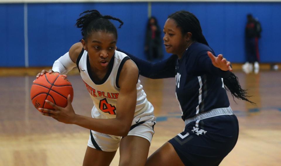 White Plains' Sequoia Layne (4) tries to drive around Saint Mary's Taryn Barbot (11) during the New York State Federation Tournament at Shaker High in Colonie, New York March 25, 2023.