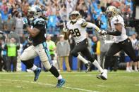 Dec 22, 2013; Charlotte, NC, USA; Carolina Panthers running back DeAngelo Williams (34) runs for a touchdown as New Orleans Saints cornerback Keenan Lewis (28) and strong safety Roman Harper (41) defend in the second quarter at Bank of America Stadium. Mandatory Credit: Bob Donnan-USA TODAY Sports