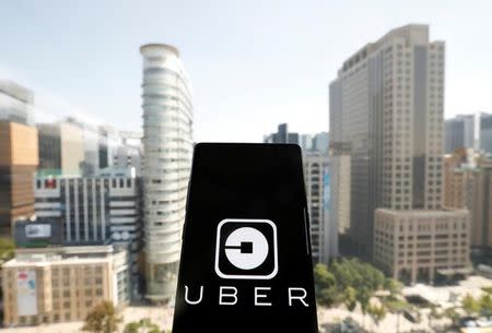 A photo illustration shows the Uber app logo displayed on a mobile phone in Seoul, South Korea, September 21, 2017. REUTERS/Kim Hong-Ji/Illustration/Files